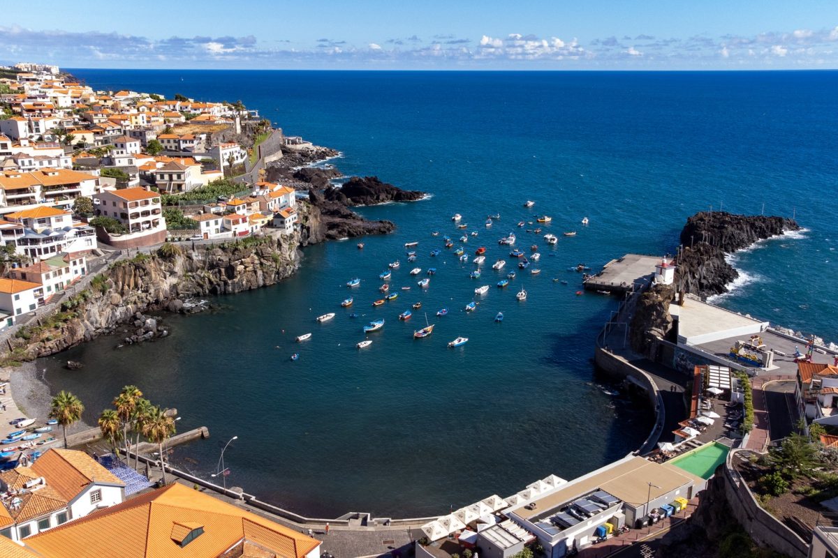 Câmara de Lobos bay with colourful fishing boats and orange-roofed houses, Madeira